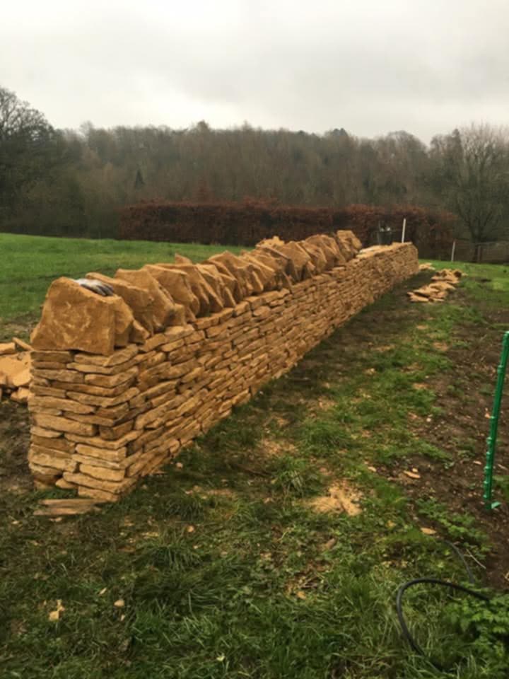 Dry stone wall craftsmanship in Cirencester, Cotswolds